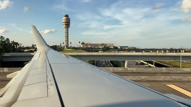 Airplane taxiing down on a bridge en route to taking off at Orlando International Airport