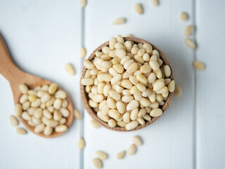 tasty and healthy pine nuts in a wooden bowl and spoon
