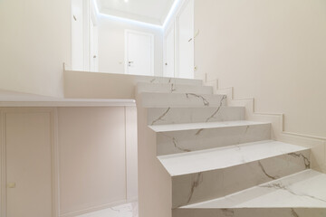 bright stairs in a new clean white house with a designer interior