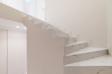 bright stairs in a new clean white house with a designer interior