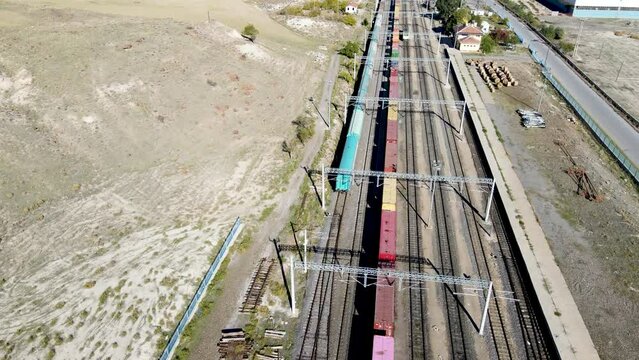 Aerial view of train station and train wagons trading flat iron and steel