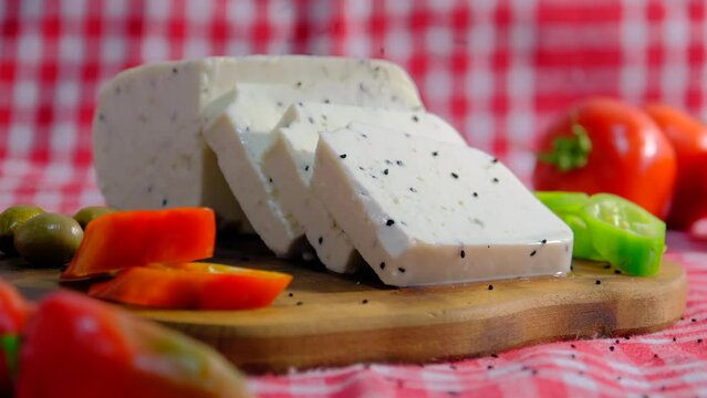 pouring black cumin on cheese, Cheese platter. 4k UHD video