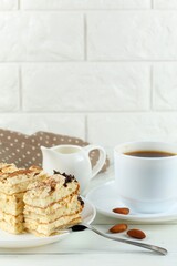 Tiramisu, coffee with milk. Sweet delicious food. Classic tiramisu dessert with cup of coffee and milk