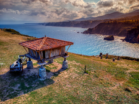 Typical granary and the chapel of La Regalina in Cadavedo, Asturias, Spain