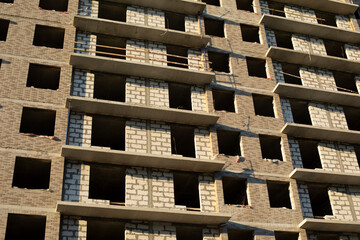 Construction of house. House made of concrete slabs. Details of construction works. Building in city.