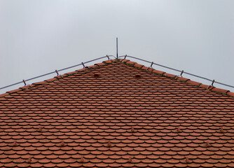 Red roof tile with a bright sky in the background