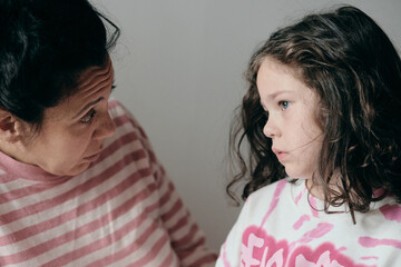 upset little girl being consoled by mom