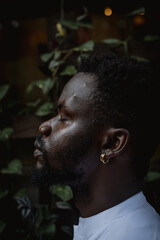 portrait of a black man in a green area