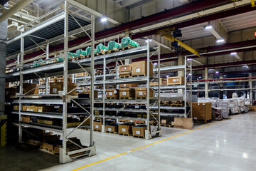 Industrial warehouse with machine spare parts and construction materials - obrazy, fototapety, plakaty