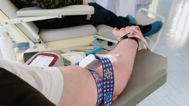The hand of a man who donates blood. Male donor gives blood in a mobile blood donation center. Blood samples