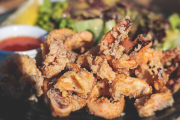 Deep fried squid fried calamari rings, grilled kalamaria tiganita, traditional Mediterranean food served in tavern, Corfu, Greek islands, Ionian sea, Greece