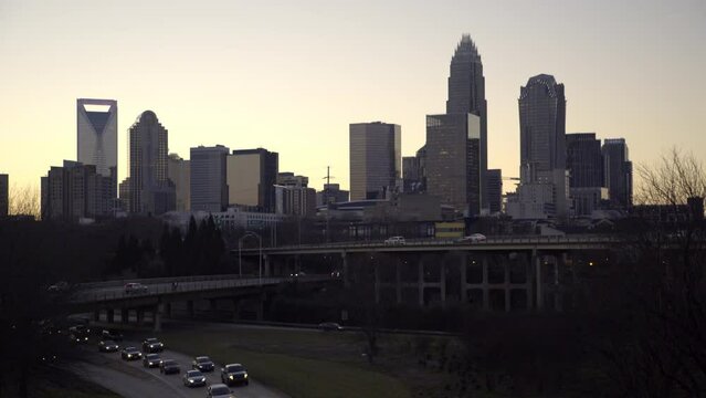 Lockdown Shot Of Illuminated Cars On Roads By Modern Buildings In City Against Clear Sky - Charlotte, North Carolina