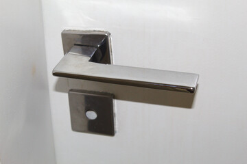 Lock and door handle made of silver metal