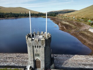 Aerial view of the historic castle tower over the Llwyn-on Reservoir in Wales