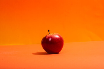 Red apples on orange background