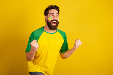 Fototapeta caucasian man with beard, brazilian, soccer fan from brazil, celebrating, yes! wow! Victory. obraz