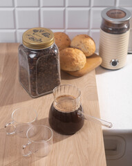 Americano in glass cups stands being poured from Turks