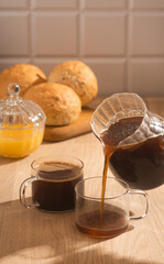 Americano in glass cups stands being poured from Turks