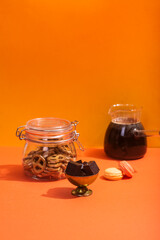 Americano in a glass jar on an orange background