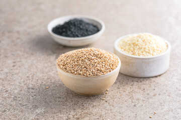 Set with different sesame seeds on stone background. top view.
