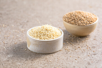 Set with different sesame seeds on stone background. top view.