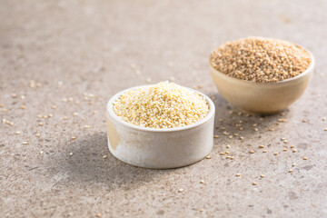 Set with different sesame seeds on stone background. top view.