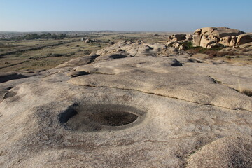 Gray volcanic stone plateau in the Bektau-Ata tract with stones, sunny