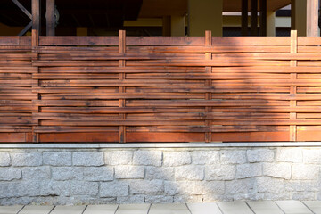 Wooden fence near house on sunny day outdoors