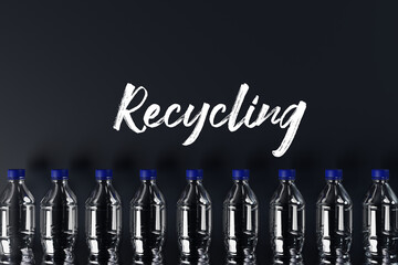 Plastic bottles with the recycling icon and painted recycling arrows and the word recycling. Concept of nature and environment protection. Plastic recycling.
