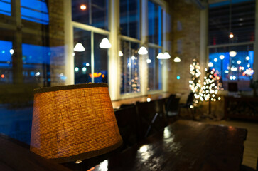 A landscape view of a lamp and table in a a vacant downtown building during the holiday season