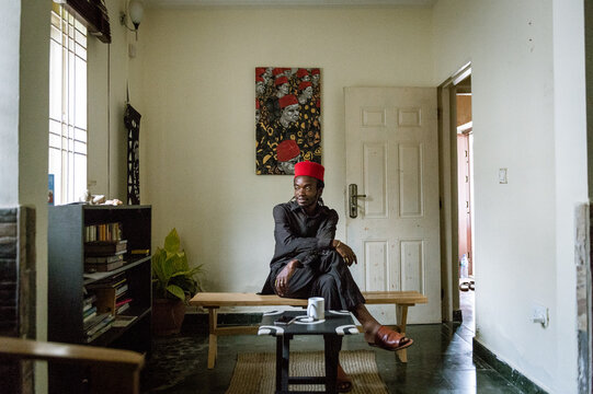 an igbo man posing for portraits in his home