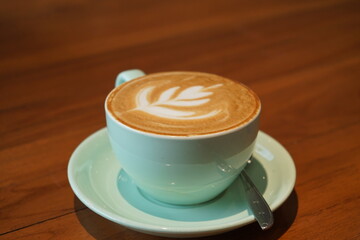 Cup of latte coffee on wooden table