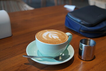 Cup of latte coffee on wooden table