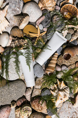 Organic cosmetic with with sea minerals. Skincare cosmetic product and shells on stone water background. Fashion showcase for cosmeics with marine ingredients.