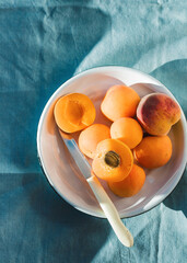 Ripe apricots on rustic background. apricots with leaves on wooden background. Ripe apricots with copy space for text. Various fresh summer fruits. Apricots on a wooden table. Top view.