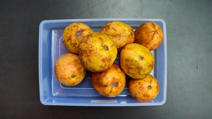 Depok, Indonesia, October 29, 2022, a pile of red guava that is almost rotten