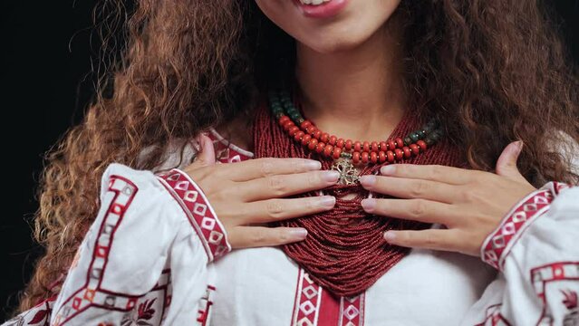 Demonstrating traditional coral jewelry necklaces. National costume of Ukraine. Ukrainian woman in legacy beads, Zgarda - archaic hutsul neck ornament of status religious purpose