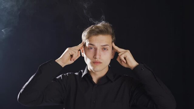 Smoke comes out of the head of the thoughtful teenager.
Smoke comes out of the head of the young man who thinks too much.
