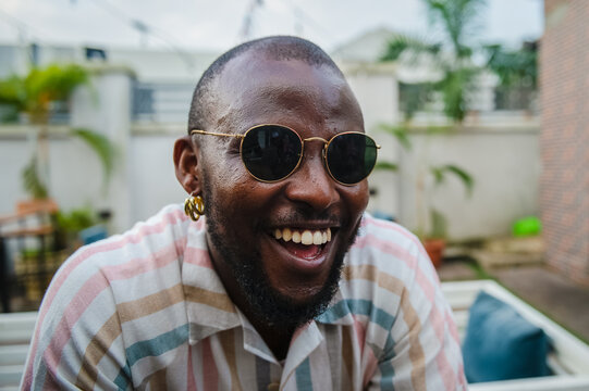 black man in sunglasses laughing