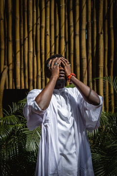 man with his hands over his eyes 
