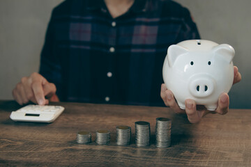 Savings and financial Investments Put a coin in the piggy bank to save money.