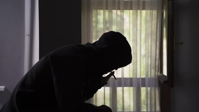 A young man lights a bite of marijuana and smokes it.
Addicted man lights lighter and smokes marijuana.
