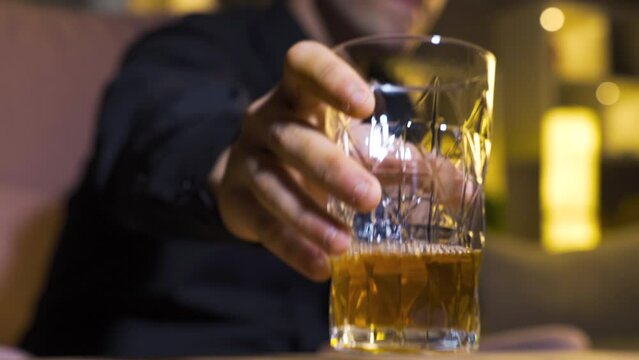 Alcohol addicted man drinking whiskey.
Alcohol addicted man drinking whiskey and tequila in glass.
