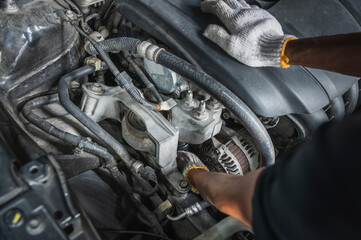 Fototapeta premium Auto mechanic checking alternators on the engine.