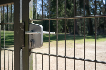 Closed gate, made of steel grating with push handle and mortise lock. No passage. Private territory.