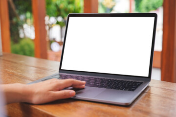 Mockup image of a woman using and touching on laptop computer touchpad with blank white desktop screen