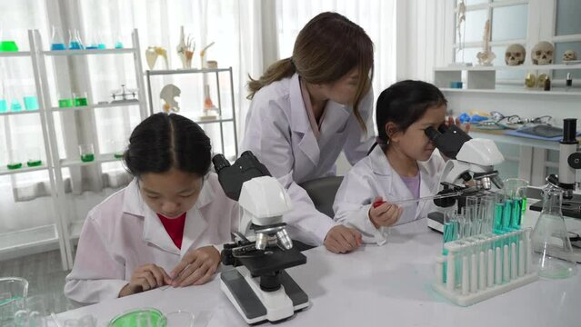 Young Asian Children Learning Science and Medicine with Teacher at School Classroom