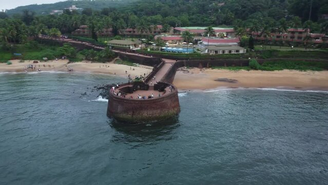 Goa, India 19th October 2022: 4k Drone shots Fort Aguada in North Goa - Seventeenth-century Portuguese fort standing on Sinquerim Beach. Popular also Watersports activities and white sand beach.  