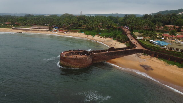Goa, India 19th October 2022: Drone shots Fort Aguada in North Goa - Seventeenth-century Portuguese fort standing on Sinquerim Beach. Popular also Watersports activities and white sand beach.  