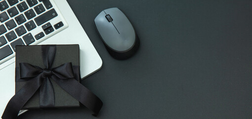 Cyber Monday and Black Friday Sale banner. Gift box and computer laptop on black